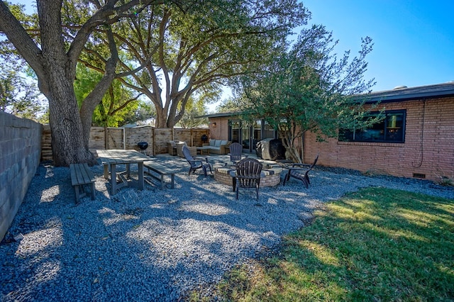 view of yard featuring a patio and an outdoor fire pit