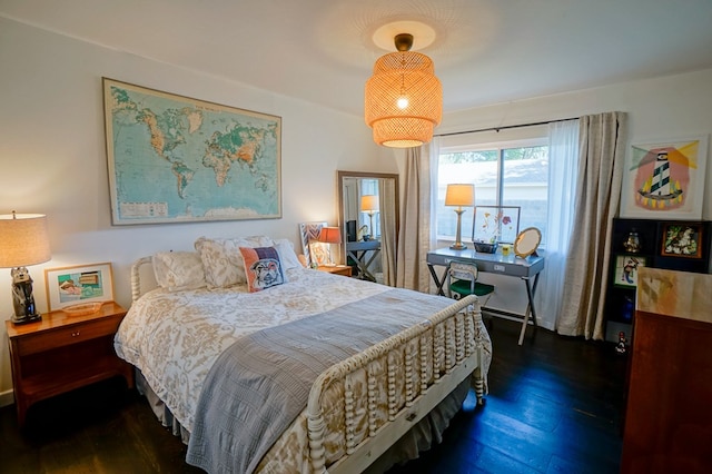 bedroom with dark hardwood / wood-style floors