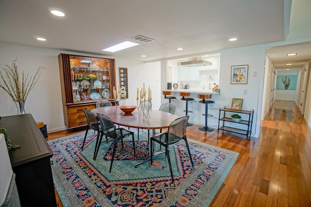 dining space featuring light wood-type flooring