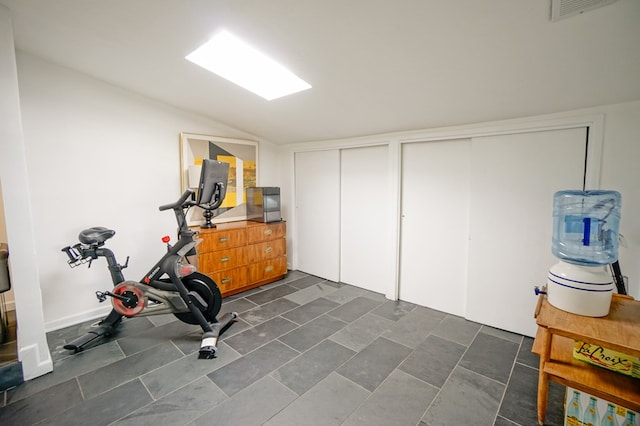 workout room with vaulted ceiling