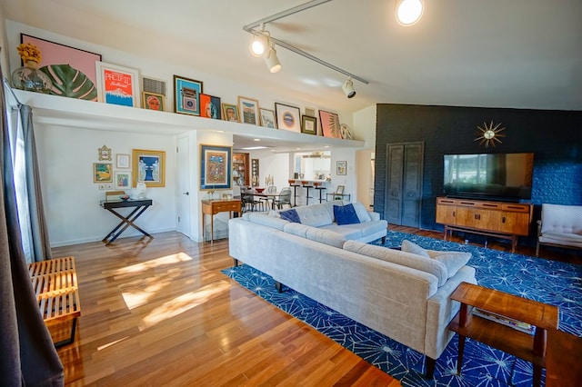 living room featuring lofted ceiling and wood-type flooring