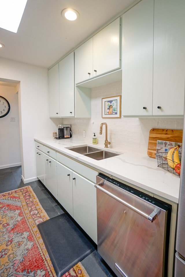 kitchen with stainless steel dishwasher, sink, decorative backsplash, and white cabinets