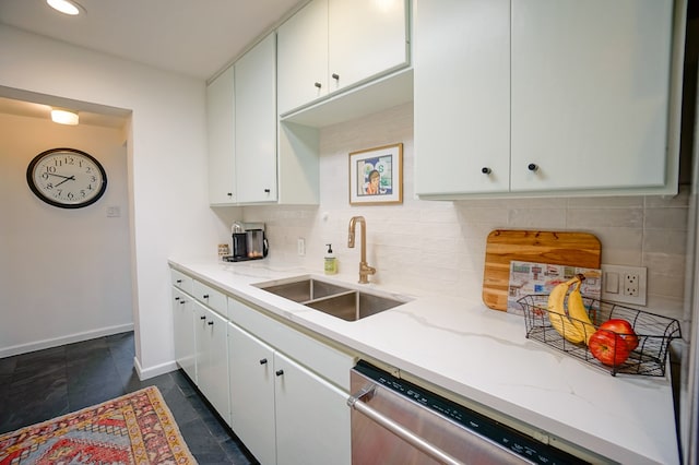 kitchen featuring tasteful backsplash, white cabinetry, dishwasher, and sink