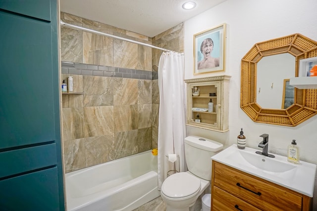 full bathroom featuring vanity, toilet, a textured ceiling, and shower / bath combo