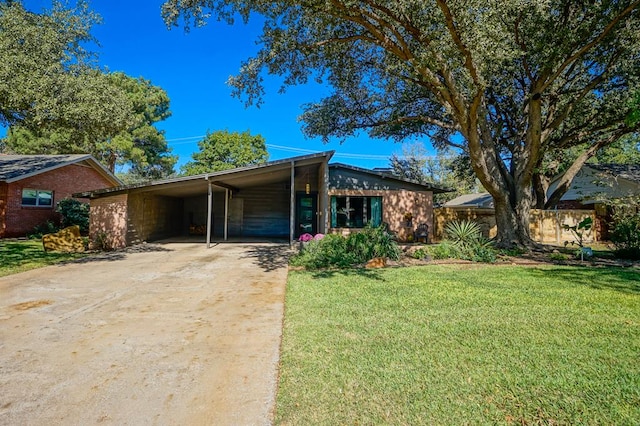 ranch-style home with a carport and a front lawn