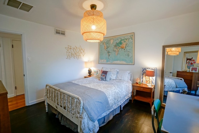 bedroom with dark hardwood / wood-style floors