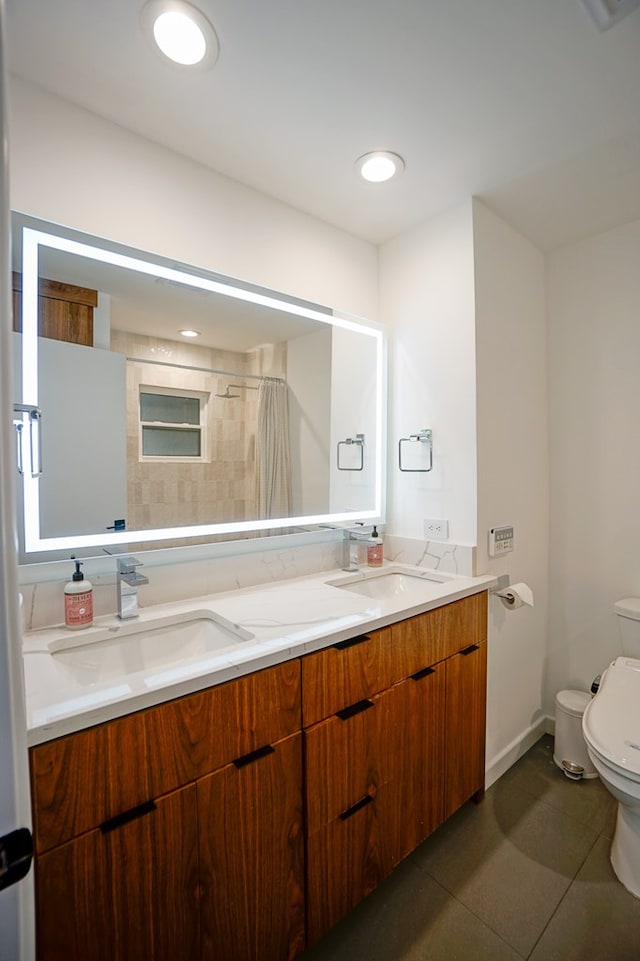 bathroom with vanity, tile patterned floors, and toilet