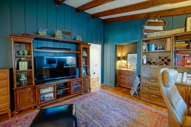 living room with beamed ceiling and light wood-type flooring