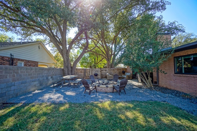 view of yard with a fire pit