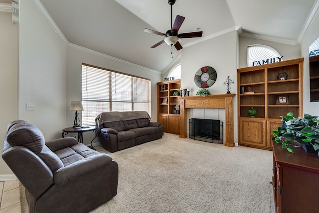 5913 Prairie Rdg, Midland, TX 79707 - living room featuring a tile fireplace, a ceiling fan, crown molding, baseboards, and light colored carpet