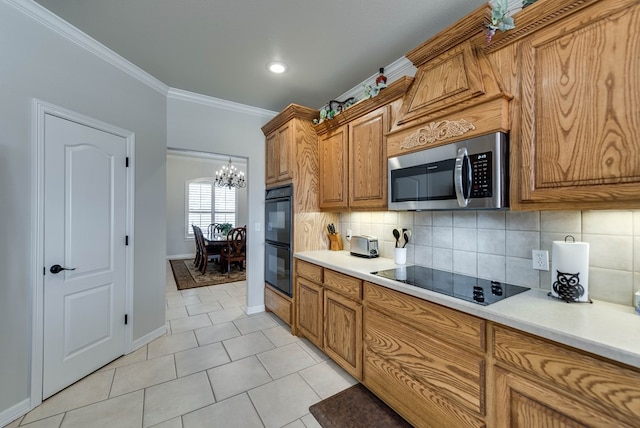 5913 Prairie Rdg, Midland, TX 79707 - kitchen with brown cabinets, an inviting chandelier, ornamental molding, black appliances, and tasteful backsplash