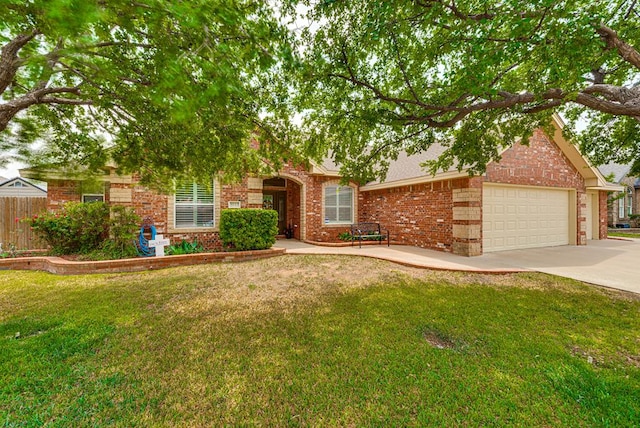 5913 Prairie Rdg, Midland, TX 79707 - view of property hidden behind natural elements featuring fence, a front lawn, an attached garage, driveway, and brick siding