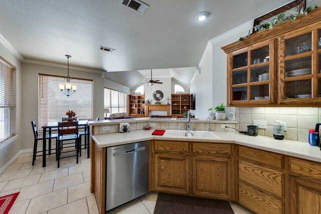 5913 Prairie Rdg, Midland, TX 79707 - kitchen featuring brown cabinets, visible vents, stainless steel dishwasher, a sink, and a peninsula