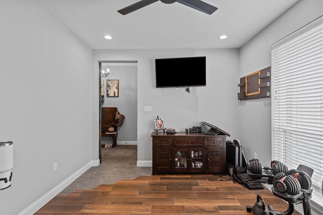 interior space featuring ceiling fan with notable chandelier, hardwood / wood-style flooring, and a wealth of natural light