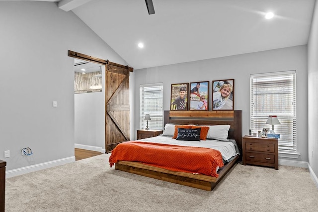 bedroom featuring a barn door, lofted ceiling with beams, multiple windows, and ceiling fan