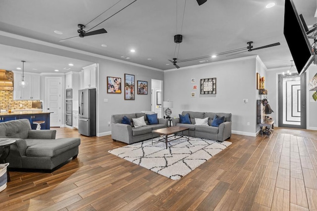 living room with crown molding and wood-type flooring