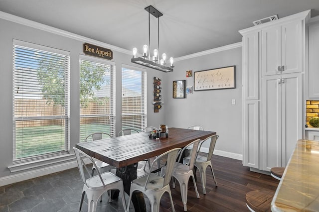 dining area with dark hardwood / wood-style flooring, a notable chandelier, and ornamental molding