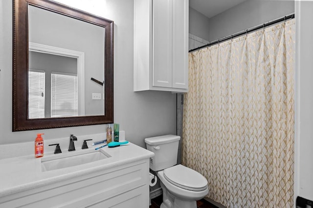 bathroom with vanity, toilet, and walk in shower