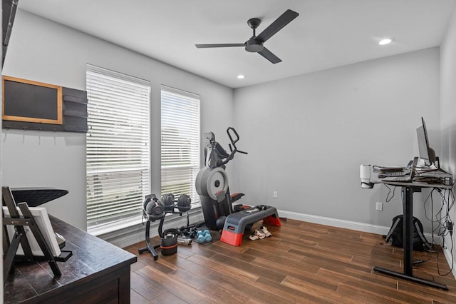 workout area with ceiling fan and dark wood-type flooring