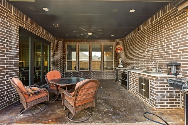 view of patio / terrace with ceiling fan and sink