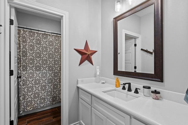 bathroom with hardwood / wood-style floors and vanity