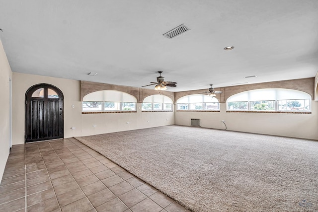 1510 W School St, Stanton, TX 79782 - unfurnished living room with a ceiling fan, carpet flooring, tile patterned flooring, a wall mounted AC, and recessed lighting