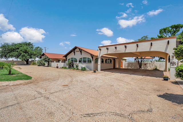 1510 W School St, Stanton, TX 79782 - view of front facade featuring dirt driveway, stucco siding, and a carport