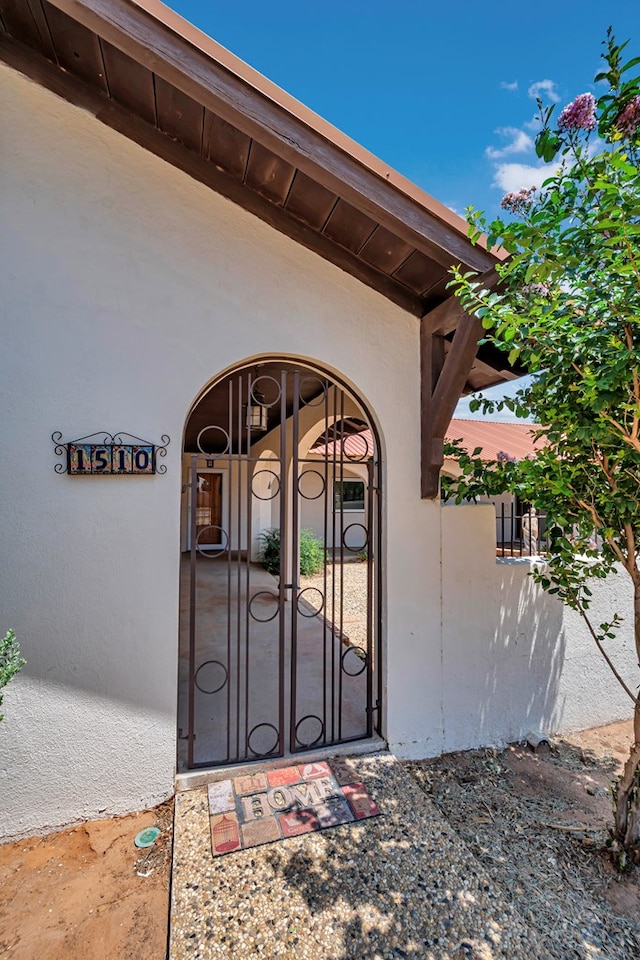 1510 W School St, Stanton, TX 79782 - property entrance featuring a gate and stucco siding