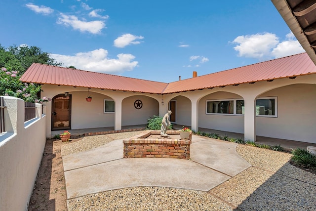 1510 W School St, Stanton, TX 79782 - view of front of home with metal roof, stucco siding, and a patio area