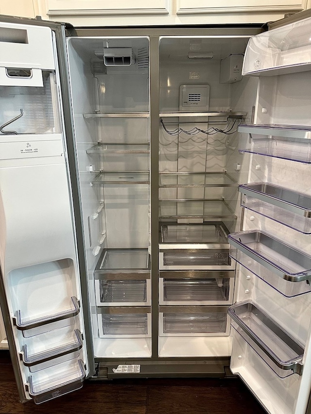room details with refrigerator with glass door and wood finished floors