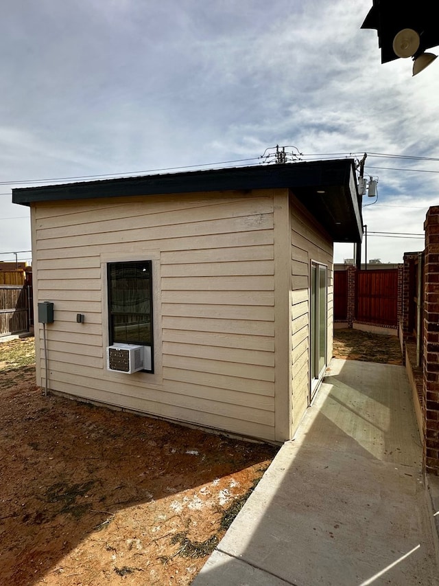 view of home's exterior with an outbuilding and a fenced backyard