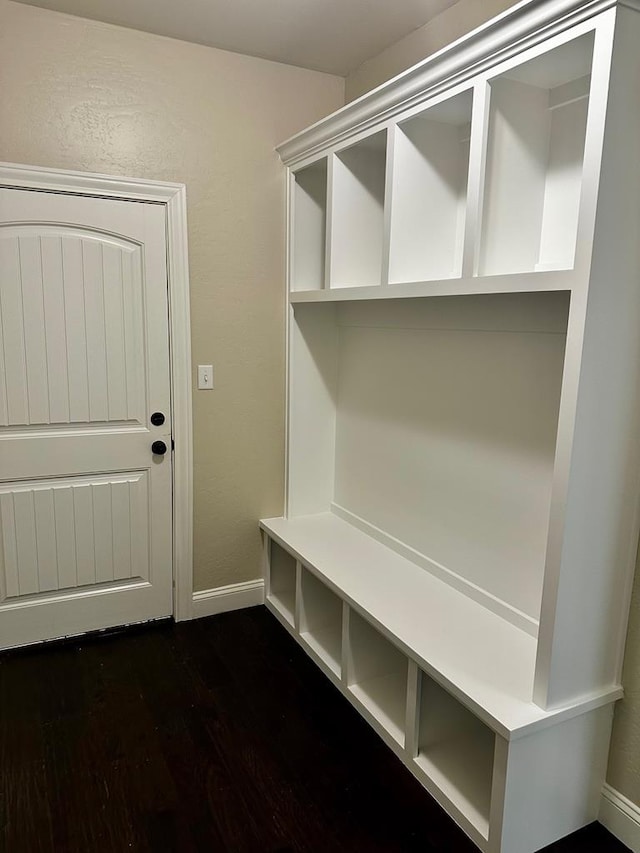 mudroom featuring dark wood-style flooring and baseboards