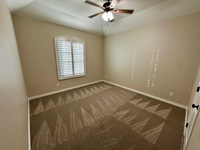 carpeted empty room with baseboards and a ceiling fan