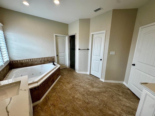 full bath featuring visible vents, a whirlpool tub, vanity, and recessed lighting