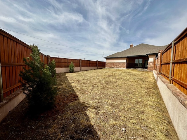 view of yard with a fenced backyard