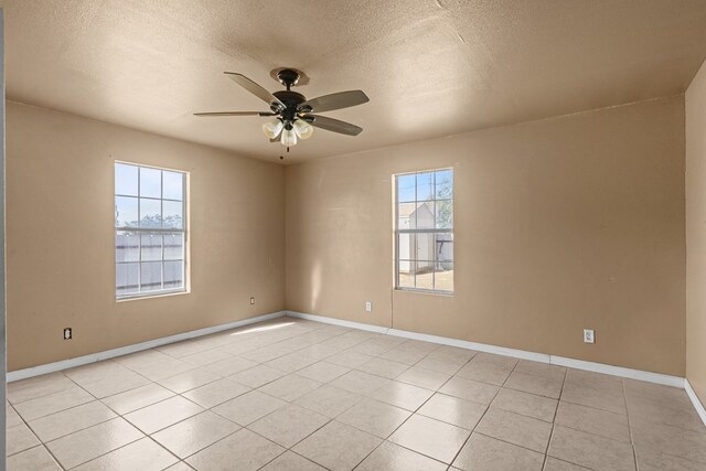 610 S Clay St, Midland, TX 79701 - spare room with a ceiling fan, a textured ceiling, baseboards, and light tile patterned floors