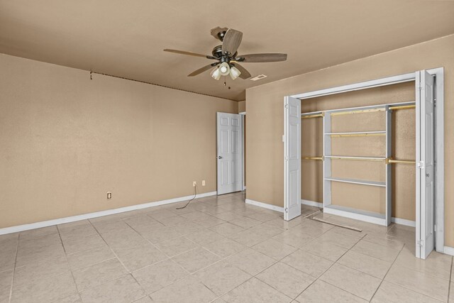 610 S Clay St, Midland, TX 79701 - unfurnished bedroom with light tile patterned floors, baseboards, a ceiling fan, and a closet