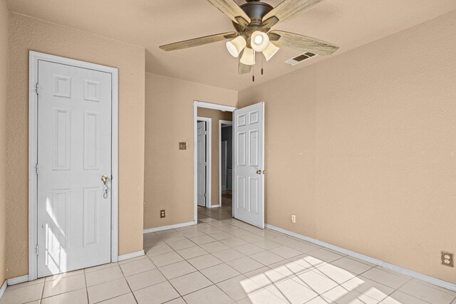 610 S Clay St, Midland, TX 79701 - unfurnished bedroom with baseboards, light tile patterned floors, and a ceiling fan
