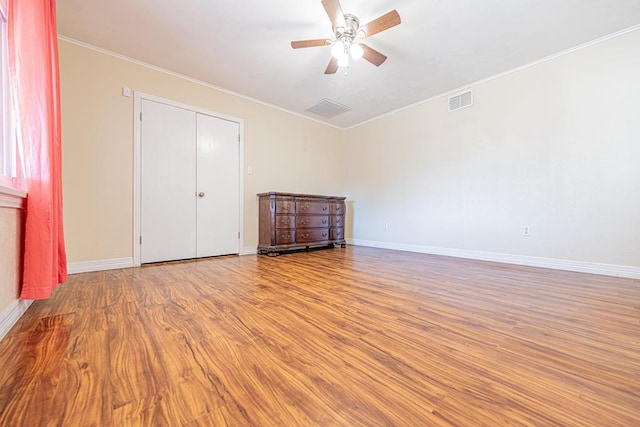 1207 Kansas, Midland, TX 79705 - unfurnished bedroom featuring wood finished floors, crown molding, and a ceiling fan