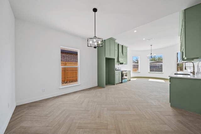 unfurnished living room featuring an inviting chandelier, sink, and light parquet floors