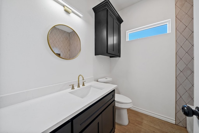 bathroom featuring hardwood / wood-style floors, vanity, and toilet