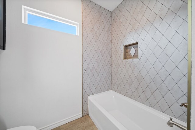 bathroom featuring a bath and hardwood / wood-style flooring