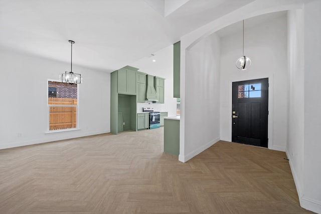 foyer featuring light parquet flooring and a chandelier