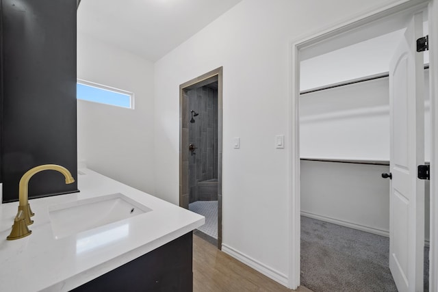 bathroom featuring vanity and tiled shower