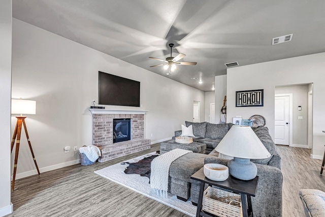 2408 Partridge St, Midland, TX 79705 - living area featuring wood finished floors, ceiling fan, and a brick fireplace