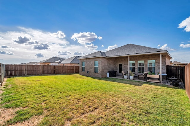 2408 Partridge St, Midland, TX 79705 - back of property with brick siding, an outdoor hangout area, a fenced backyard, a patio area, and a shingled roof