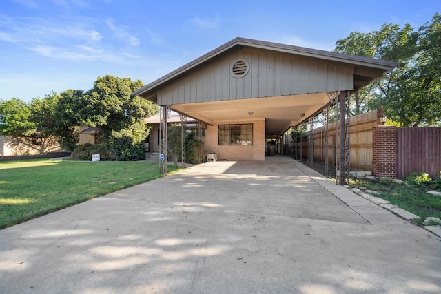 view of front of home with a front lawn and a carport