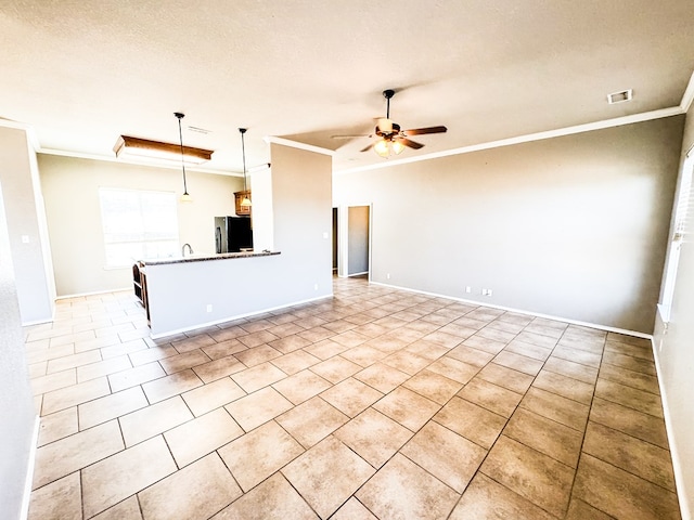 interior space featuring decorative light fixtures, a textured ceiling, freestanding refrigerator, crown molding, and ceiling fan