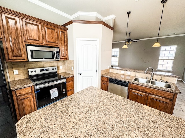 kitchen with a sink, tasteful backsplash, appliances with stainless steel finishes, a peninsula, and crown molding