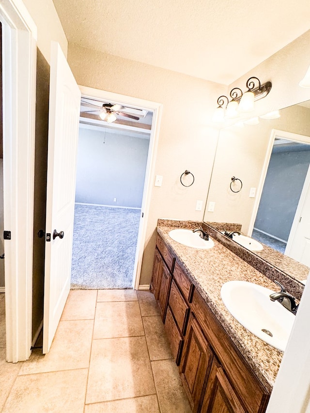 bathroom featuring a sink, double vanity, ceiling fan, and tile patterned floors